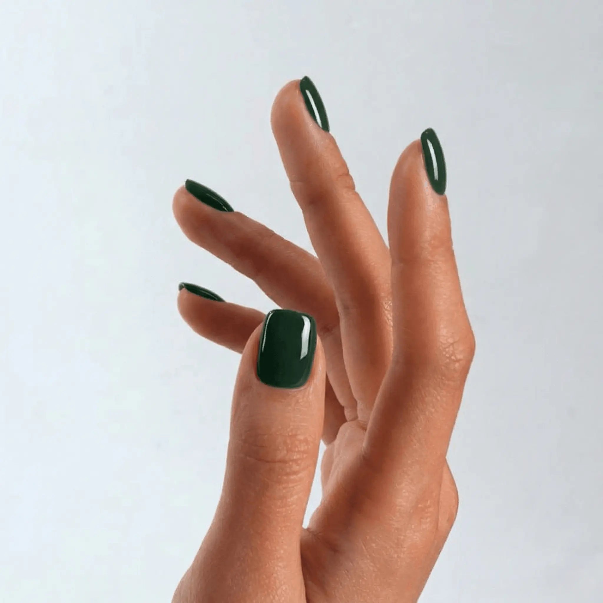 Close-up of a professional square-shaped manicure using S&L Gel Polish No. 074 Benjamin’s Green solid green polish.