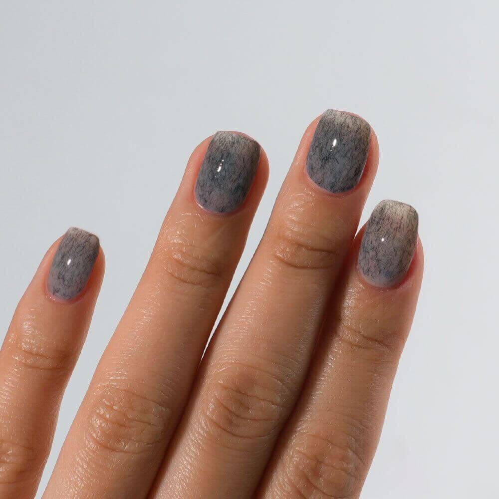 Detailed view of S&L No. 079 Nimbus Grey gel polish on square nails with a high-gloss shiny finish.
