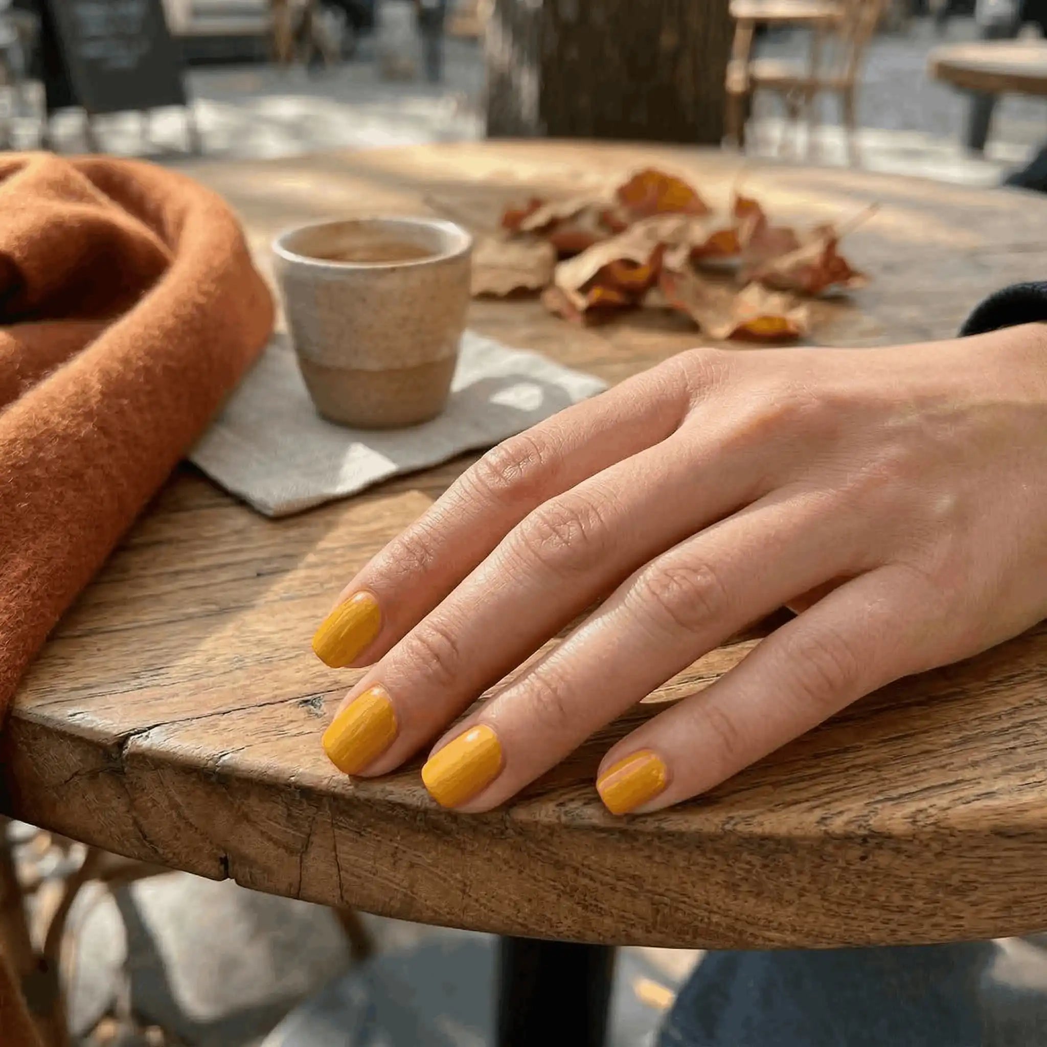 Minimalist lifestyle photography featuring a hand model with square nails in S&L No. 048 Canary Yellow solid yellow.