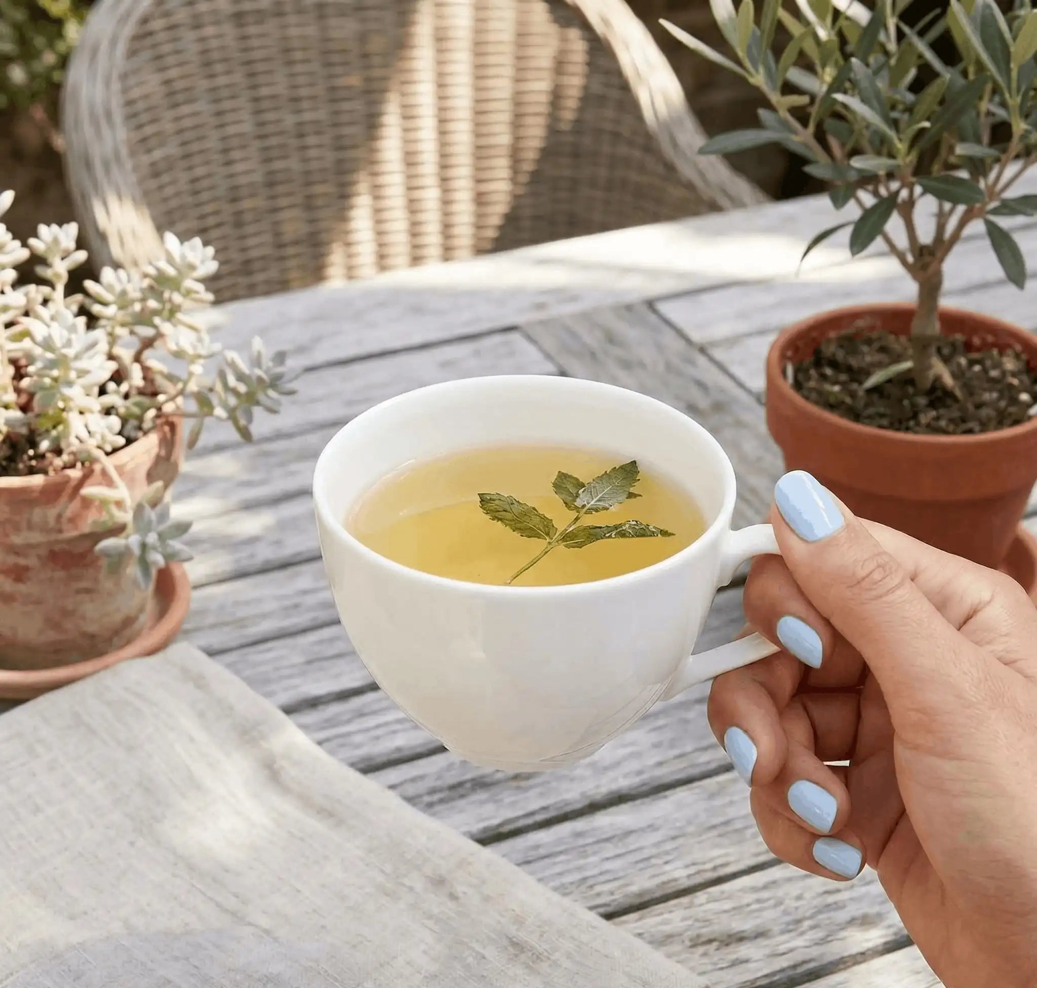 Minimalist lifestyle photography featuring a hand model with square nails in S&L No. 008 Serenade Of Water solid blue.