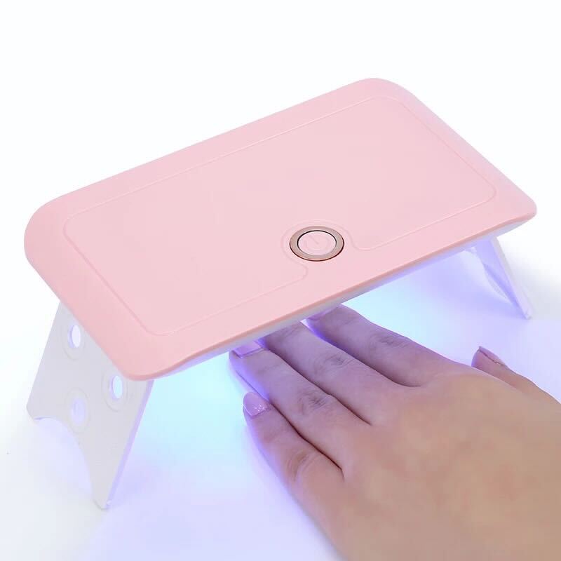 Hand under UV light of S&L Gel Nail Kit