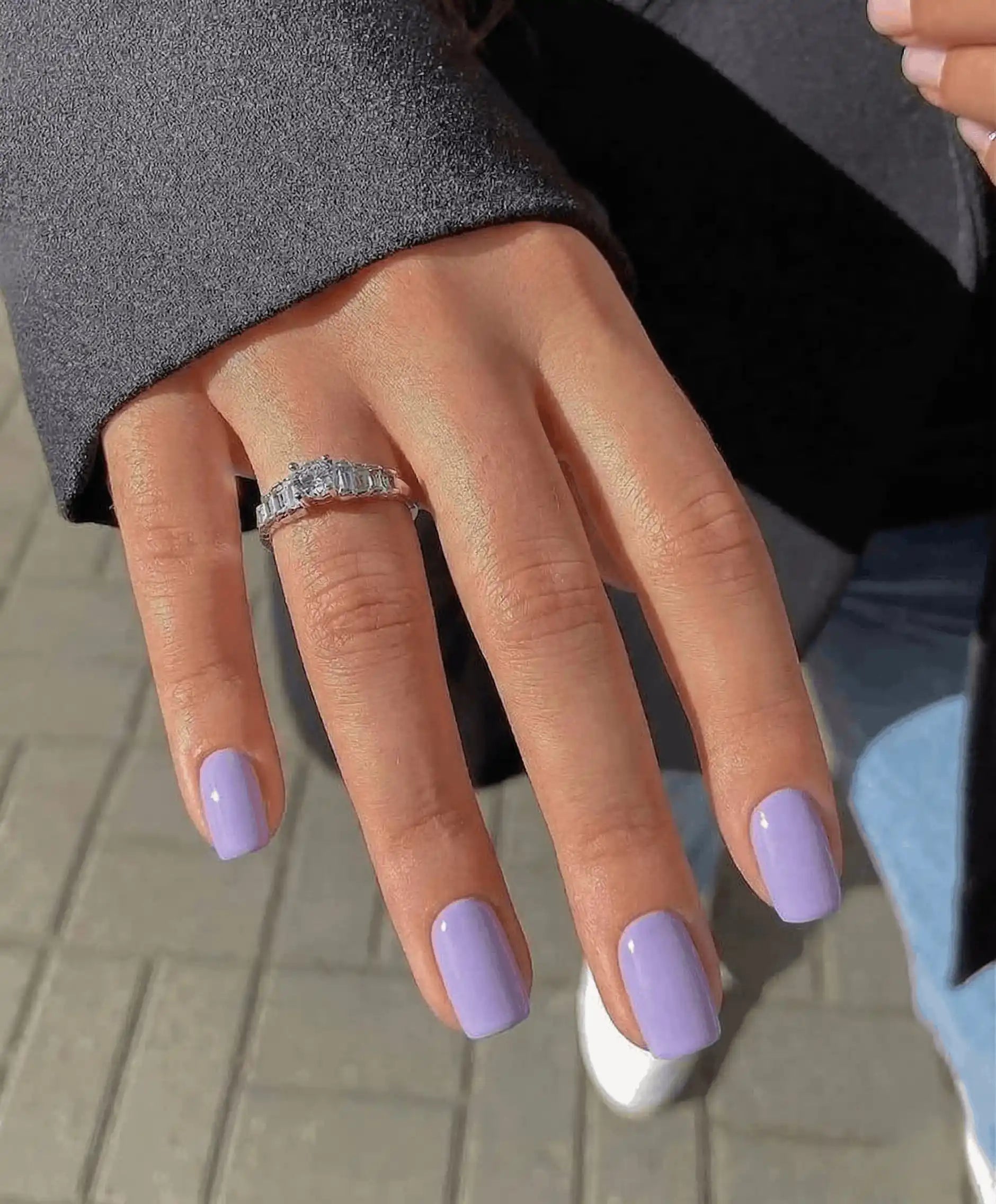 Minimalist lifestyle photography featuring a hand model with square nails in S&L No. 033 Lavender Haze solid purple.