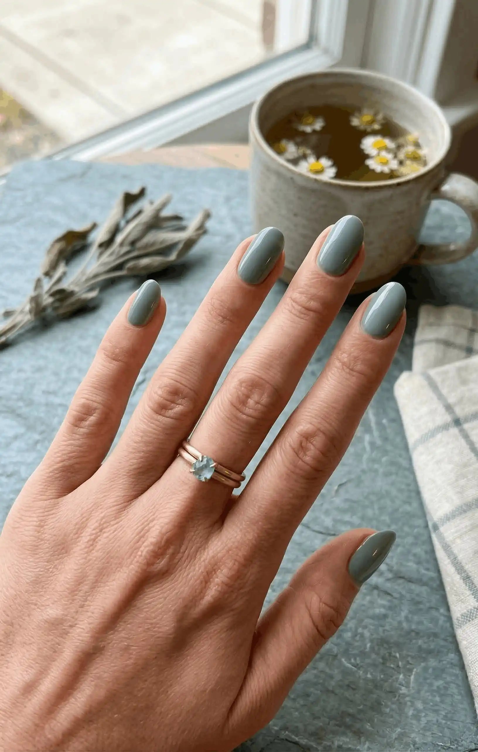 Minimalist lifestyle photography featuring a hand model with square nails in S&L No. 071 Seafoam Mist solid minty green.