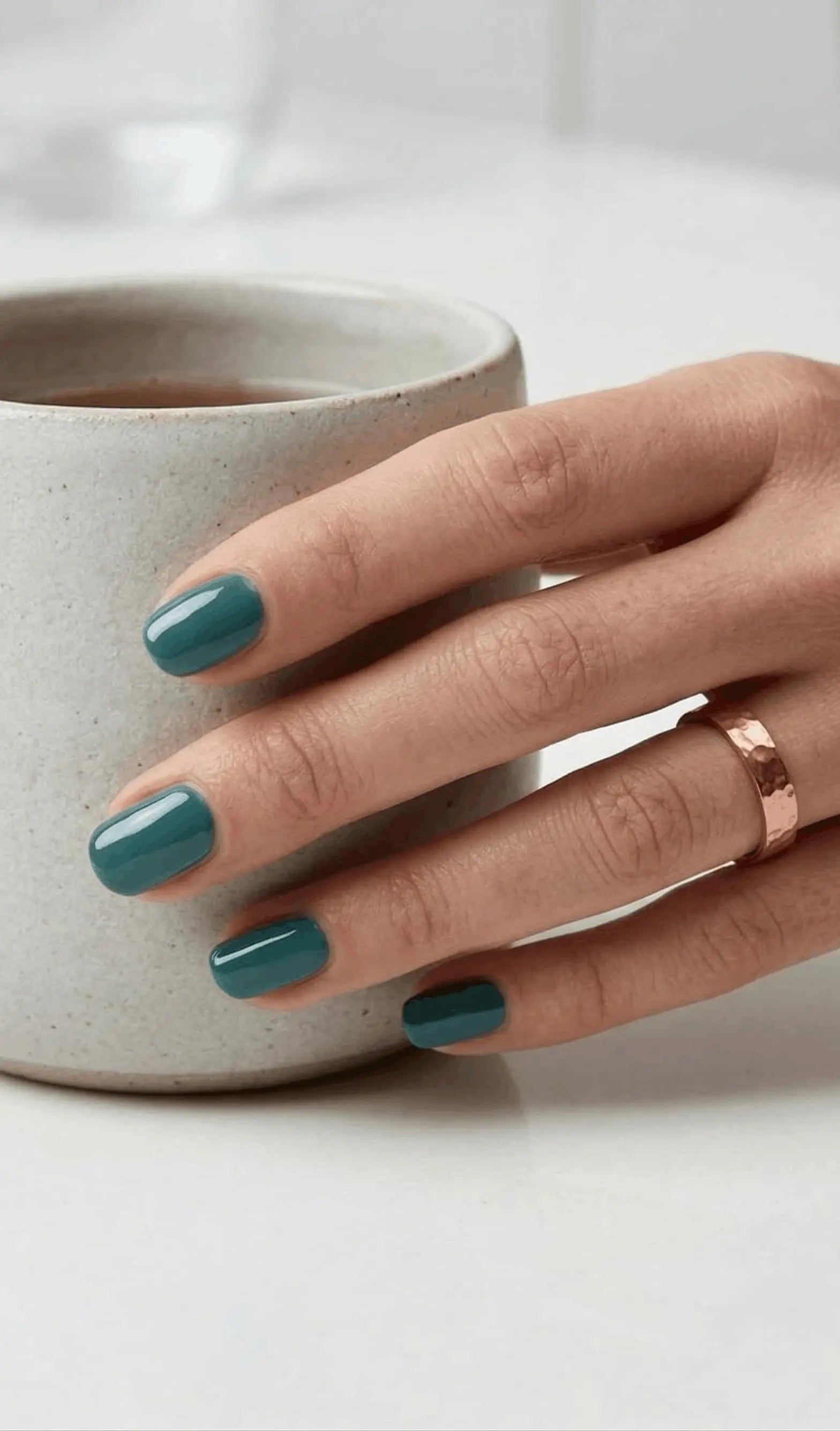 Minimalist lifestyle photography featuring a hand model with square nails in S&L No. 072 Tuscan Teal solid green.