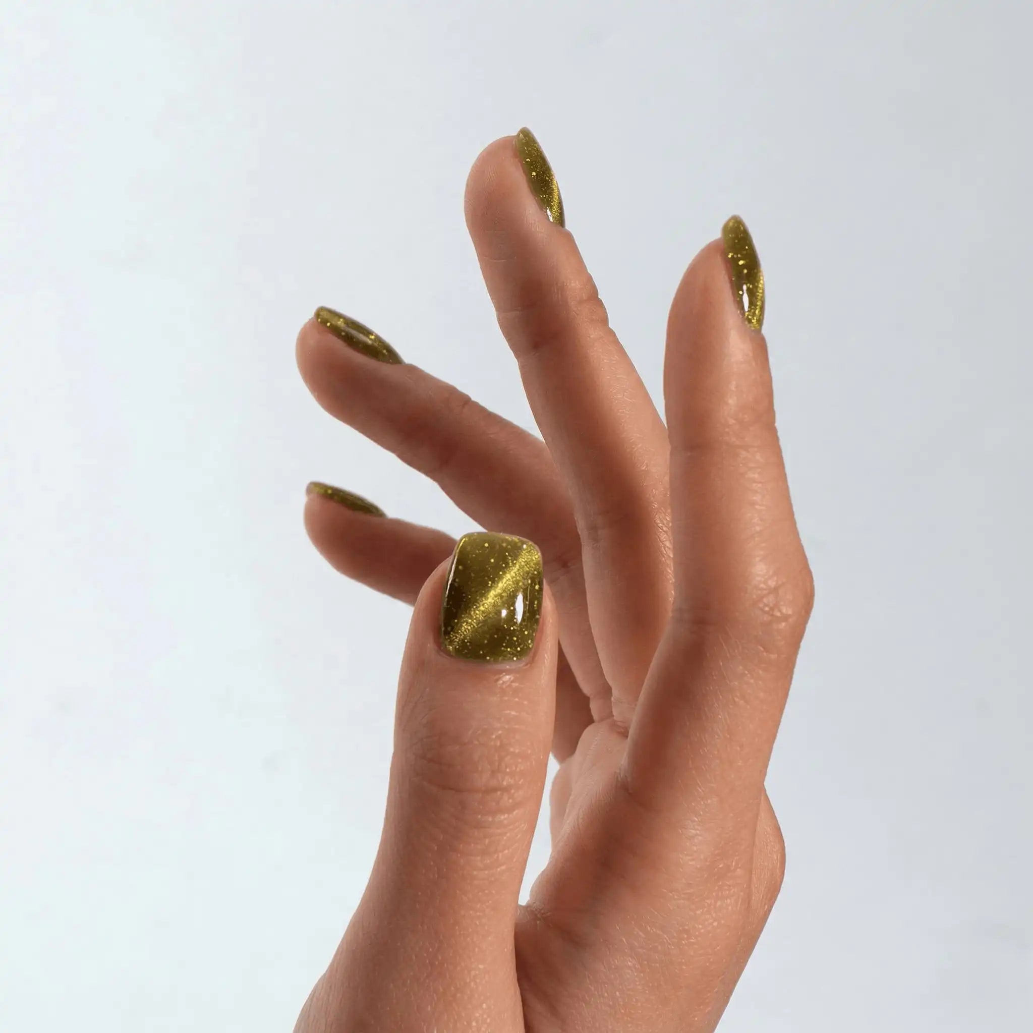 Close-up of a professional square-shaped manicure using S&L Gel Polish No. 085 Nebula green cat-eye polish.