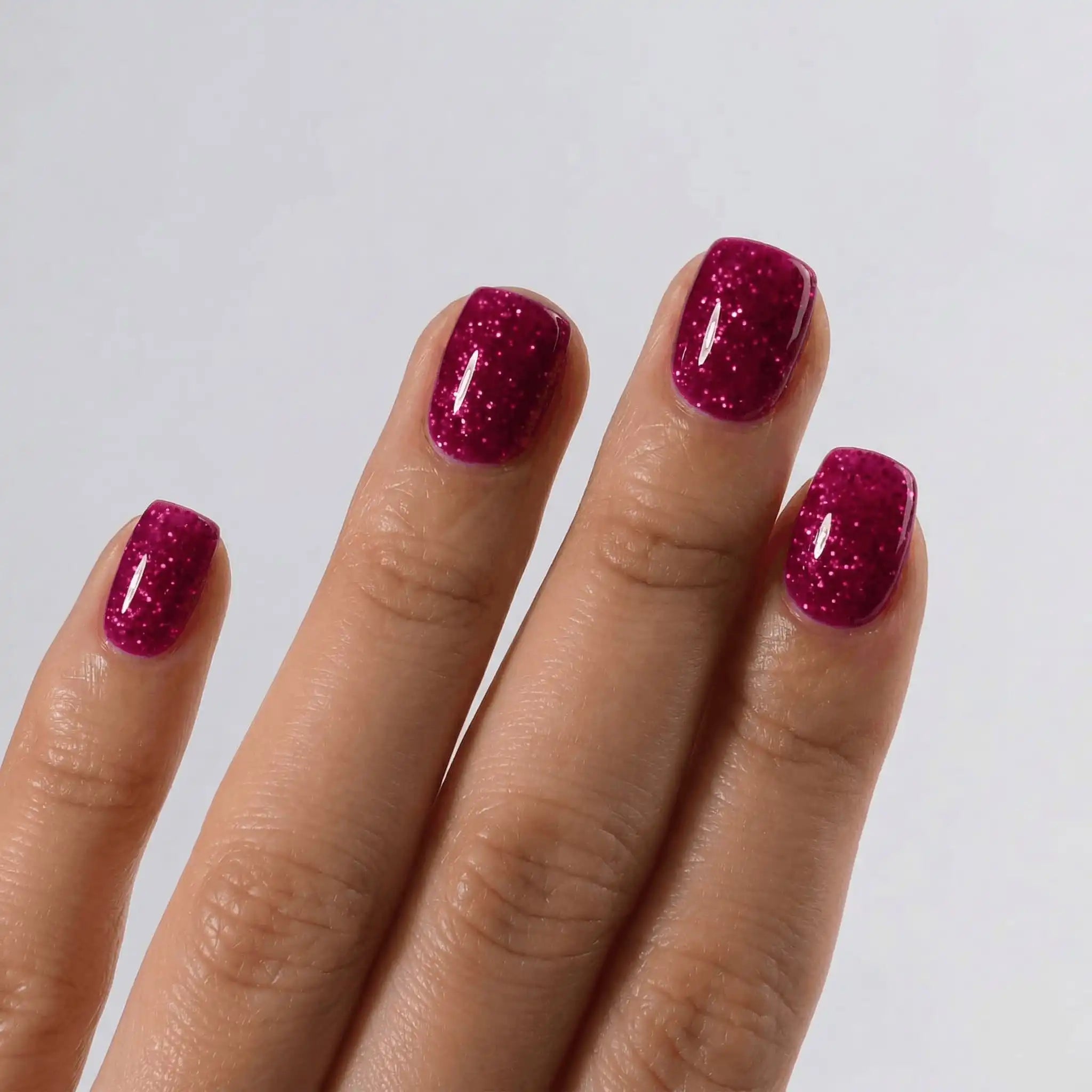 Close-up of a professional square-shaped manicure using S&L Gel Polish No. 088 Double Lucky Red sparkle polish.