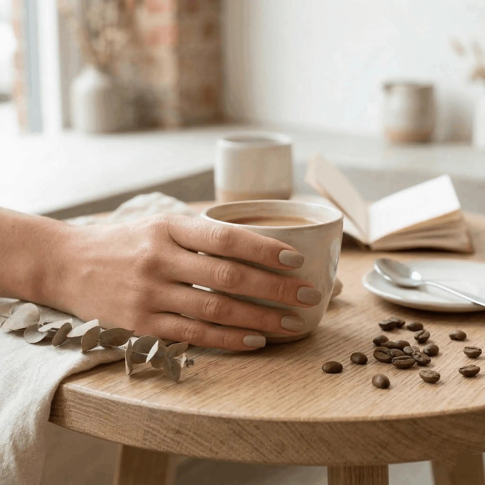 Minimalist lifestyle shot of a hand model wearing S&L No 022 Little Bear gel polish holding a coffee cup.