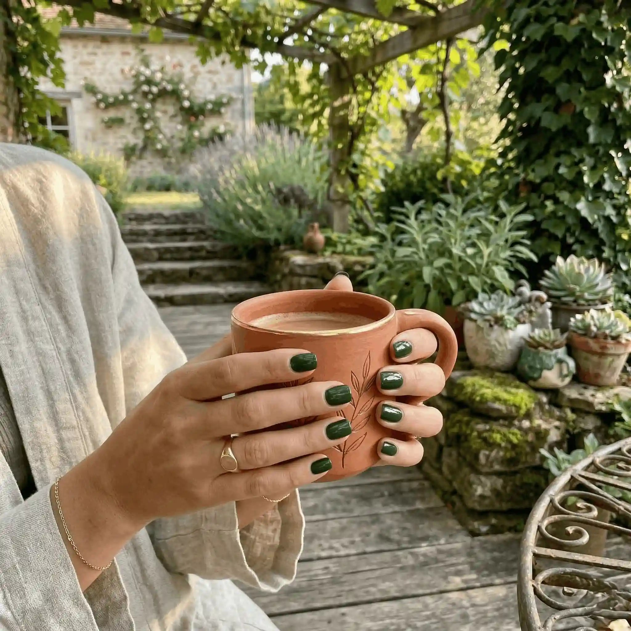 Minimalist lifestyle photography featuring a hand model with square nails in S&L No. 038 Deep Emerald solid green.