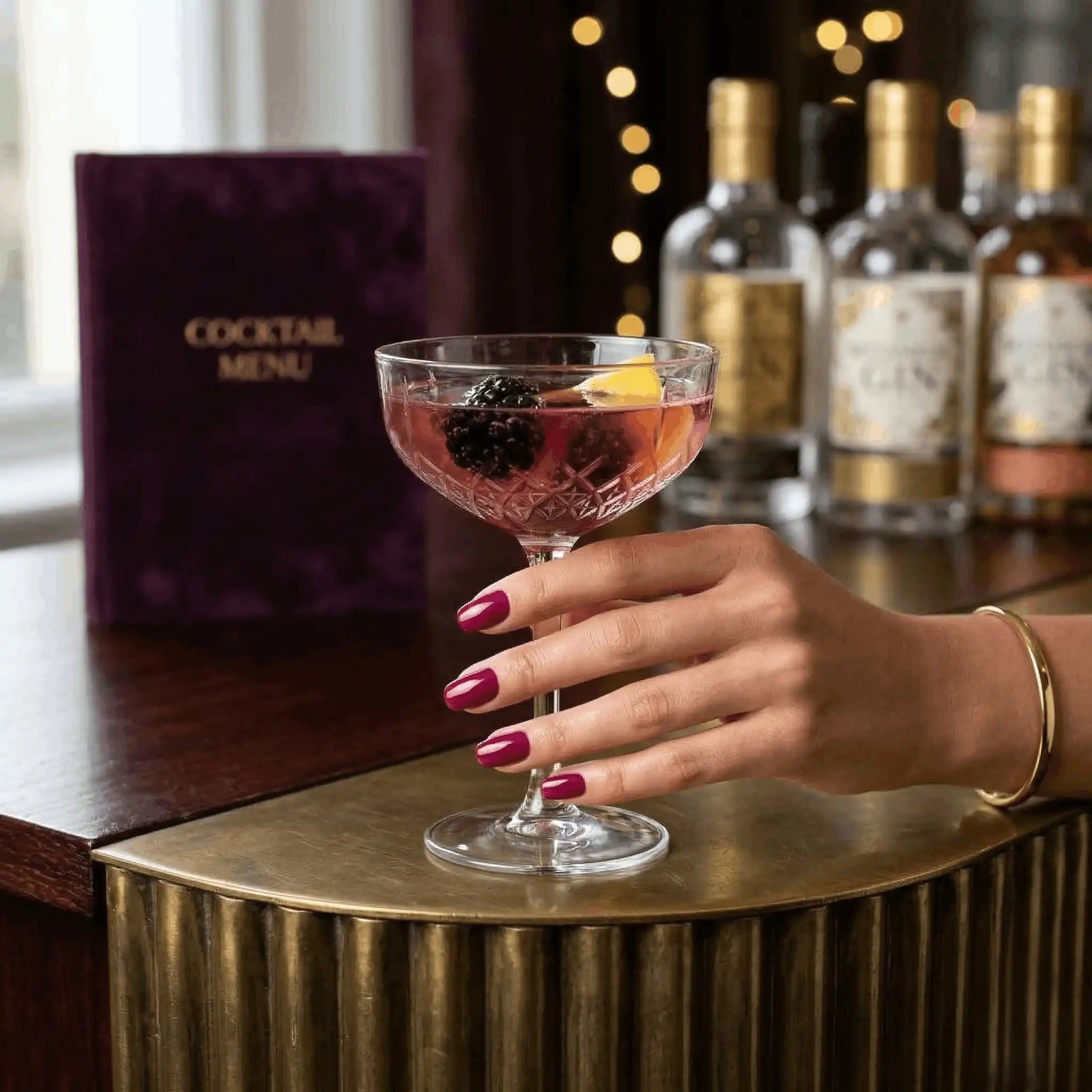 Minimalist lifestyle photography featuring a hand model with square nails in S&L No. 044 Carmine Red solid red.