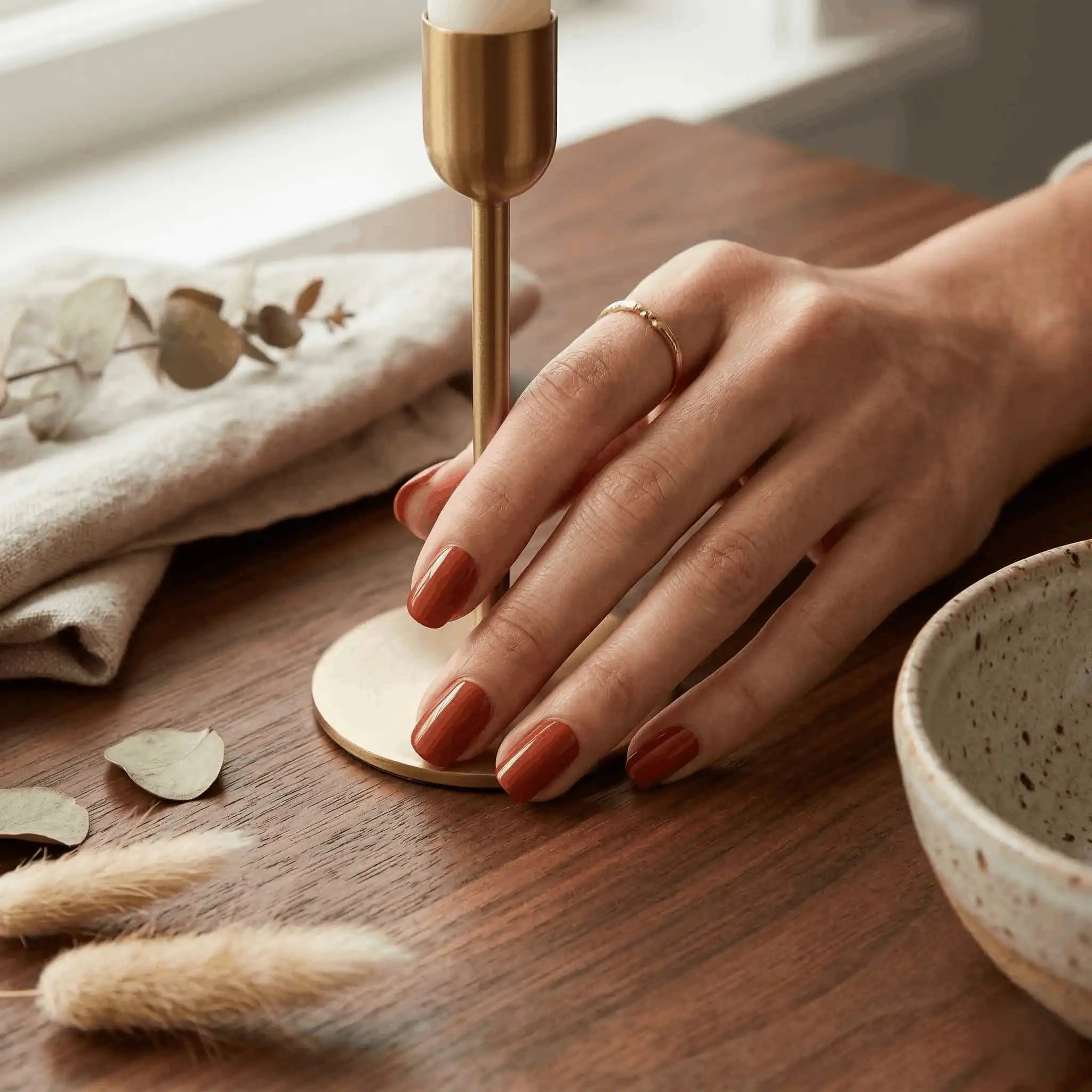Minimalist lifestyle photography featuring a hand model with square nails in S&L No. 045 Qin Dynasty solid orange-brown.