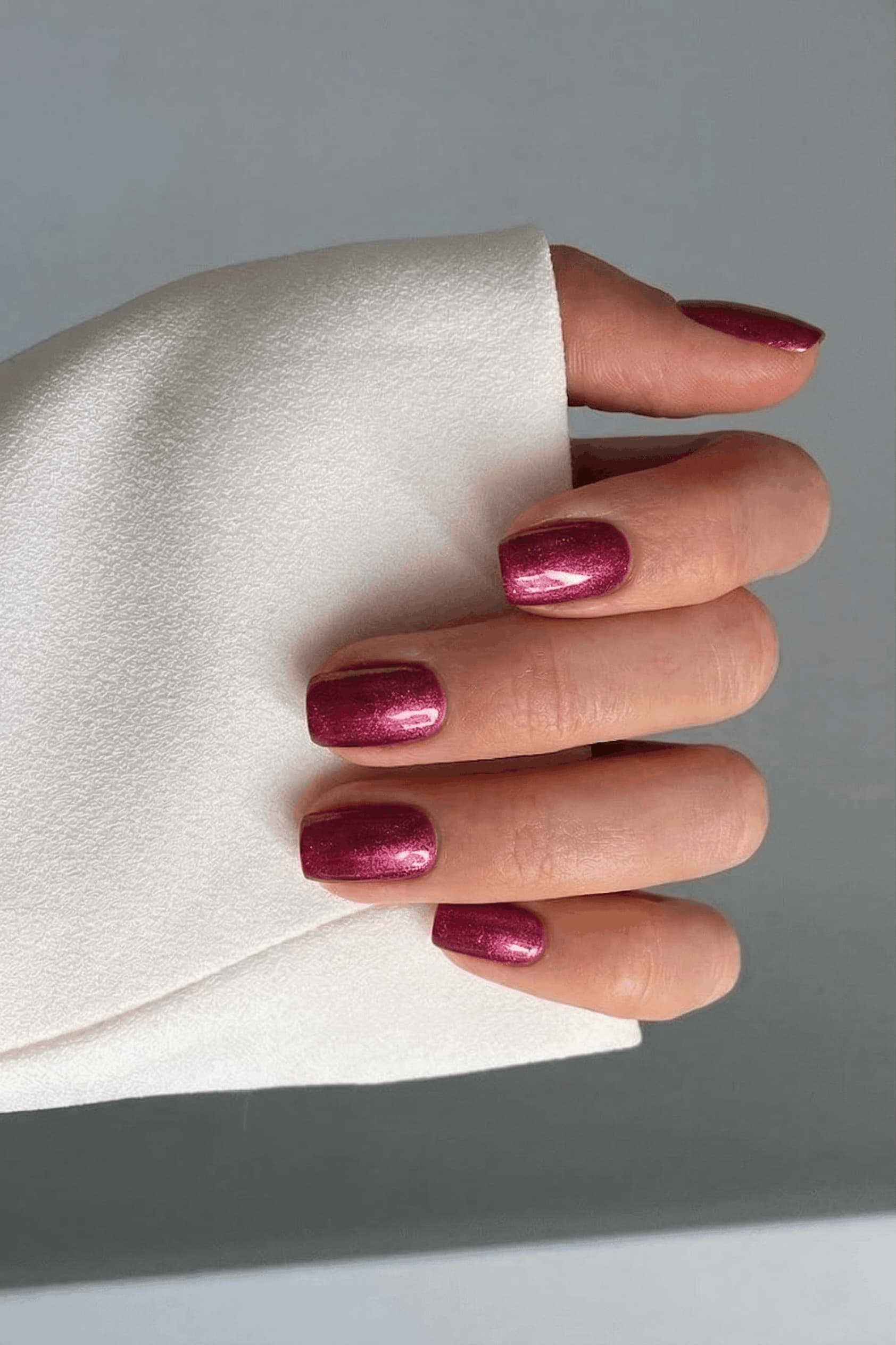 Hand with S&L red metallic nail polish 