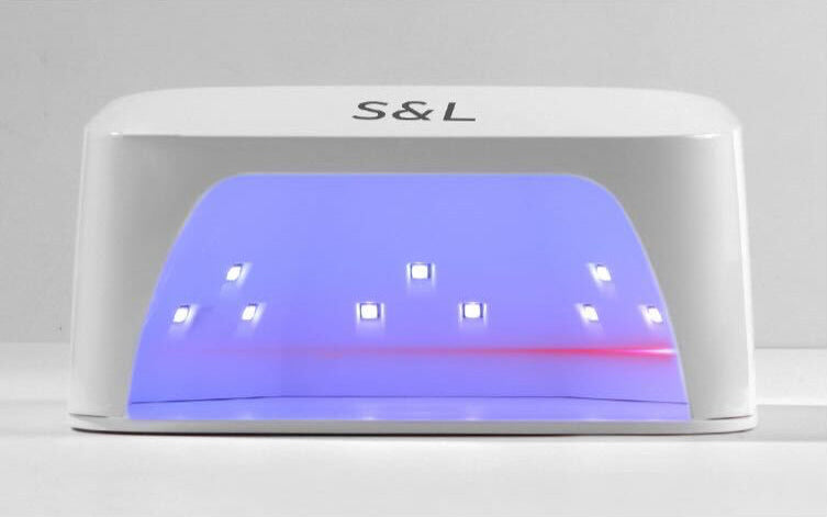 Front view of S&L UV LED nail lamp with smart infrared sensor for efficient curing and extended lamp life with grey background