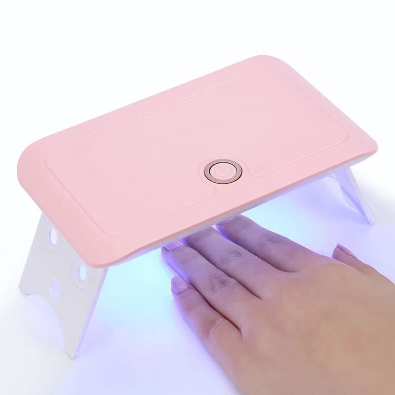 Hand under UV light of S&L Gel Nail Kit 